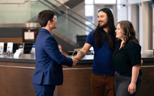 Husband and Wife shaking banker's hand
